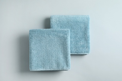 Photo of Fresh fluffy folded towels on grey background, top view. Mockup for design