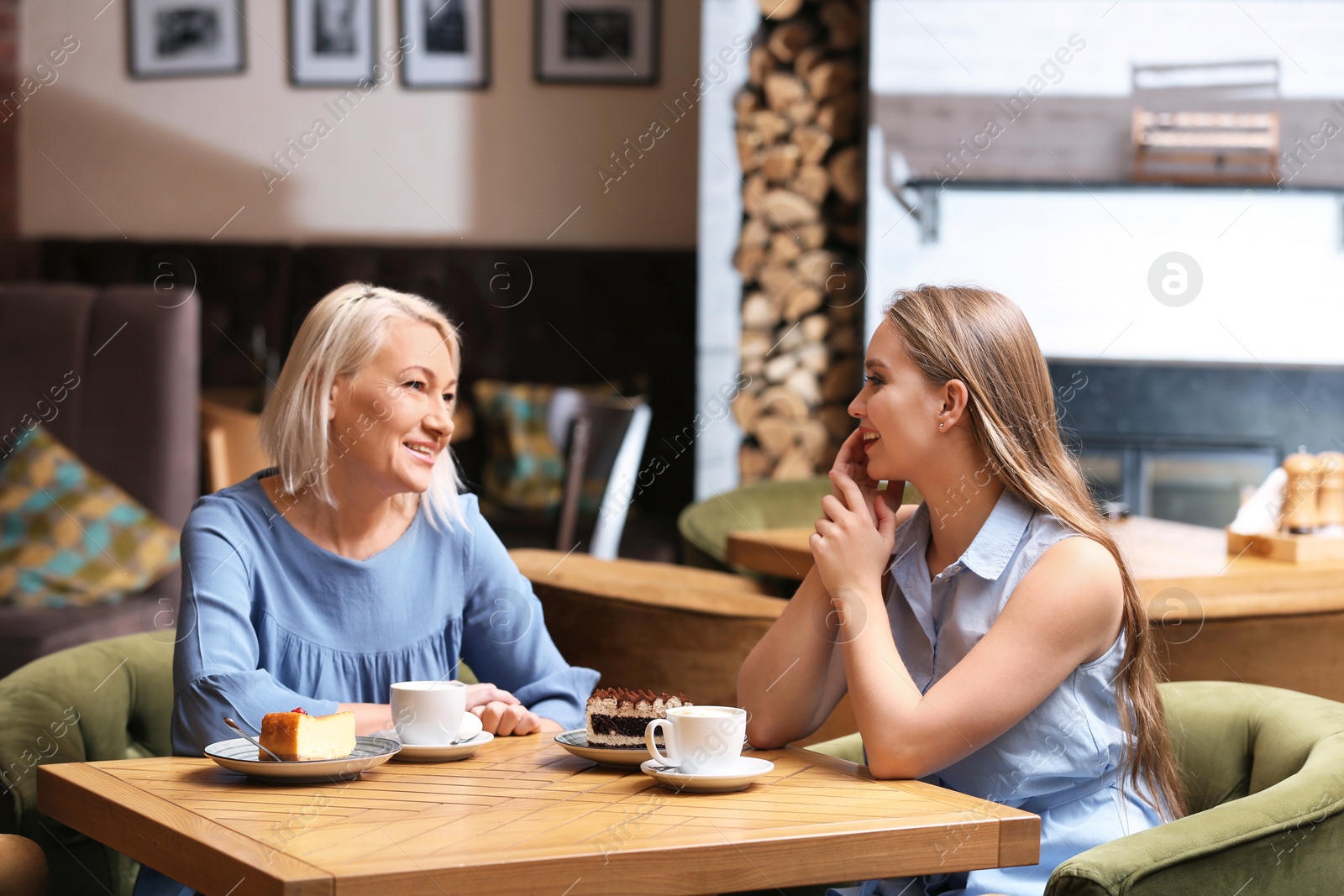 Photo of Mother and her adult daughter spending time together in cafe