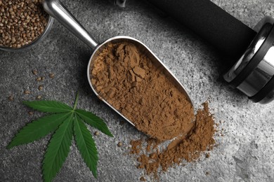 Photo of Hemp protein powder, fresh leaf, seeds and dumbbell on grey table, flat lay