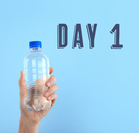 Change your life. Text Day 1 and woman holding bottle of water on light blue background