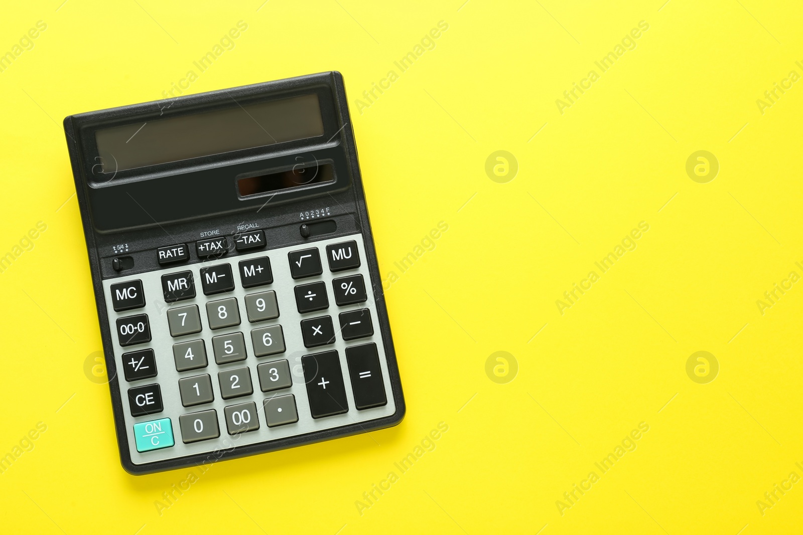 Photo of Modern calculator on yellow background, top view. Space for text