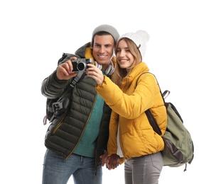 Photo of Couple with camera on white background. Winter travel