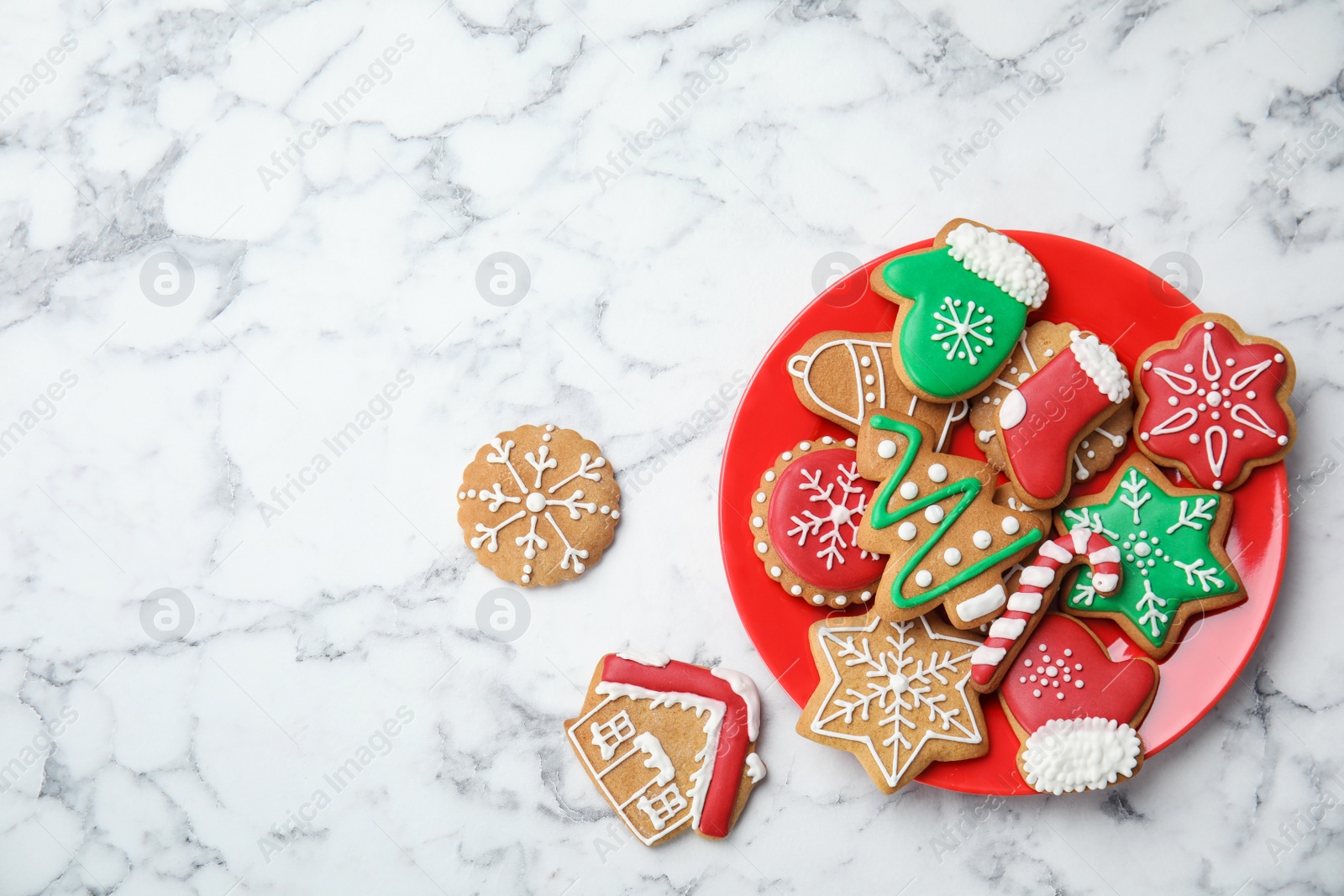 Photo of Plate with tasty homemade Christmas cookies on marble table, top view