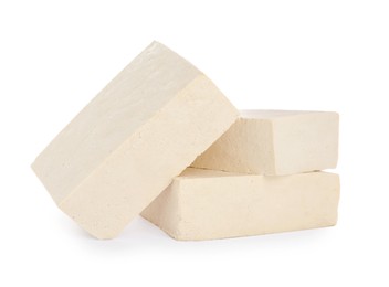 Blocks of delicious raw tofu on white background