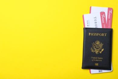 Photo of Passport with avia tickets on yellow background, top view and space for text. Travel agency concept
