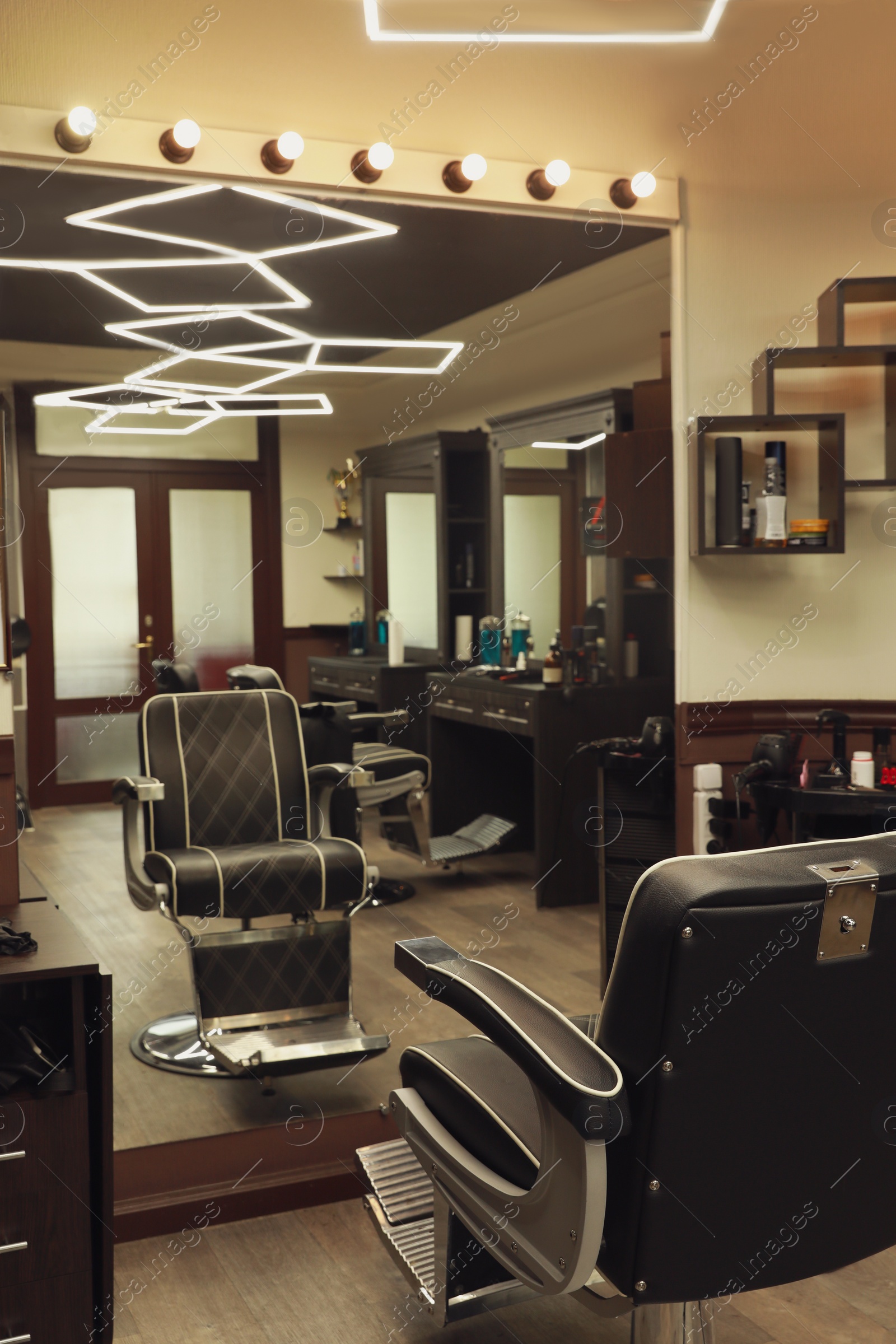 Photo of Stylish hairdresser's workplace with professional armchair in barbershop