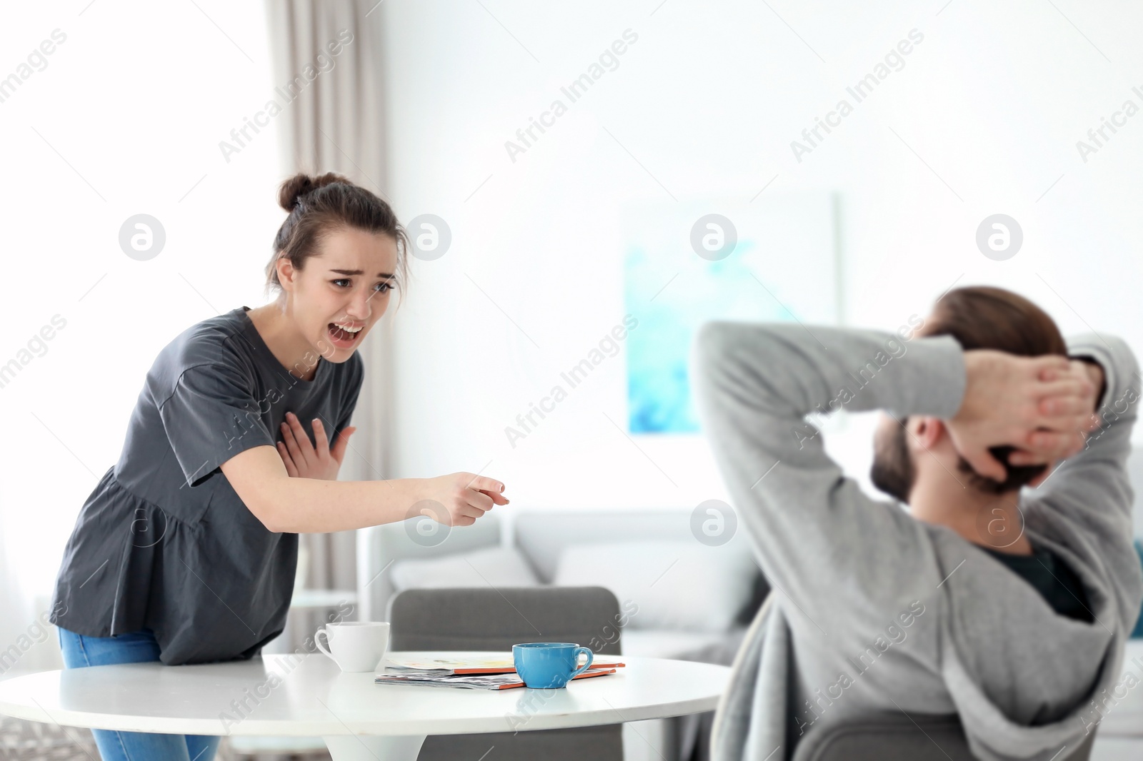 Photo of Young couple having argument at home