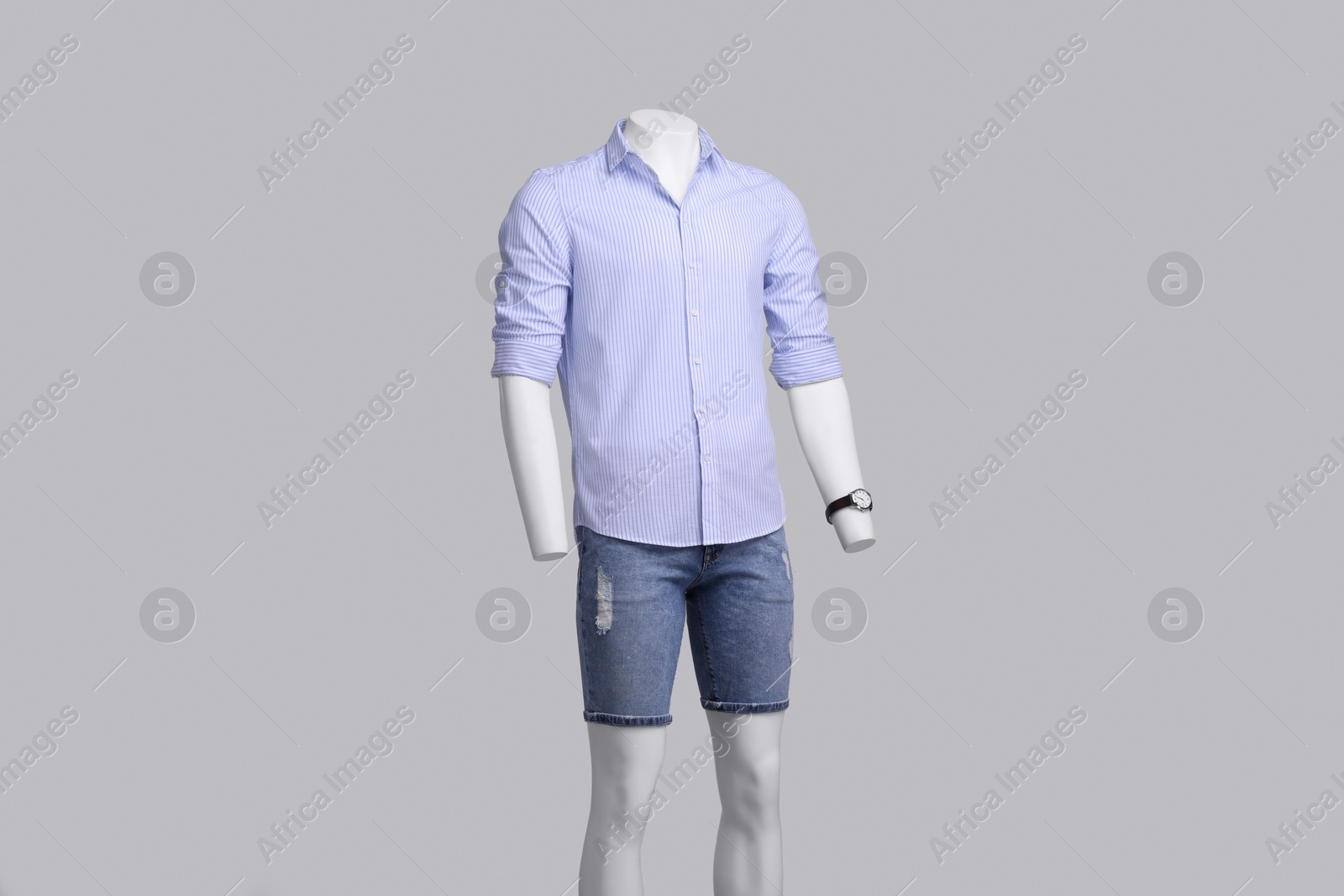 Photo of Male mannequin dressed in stylish shirt and denim shorts on grey background