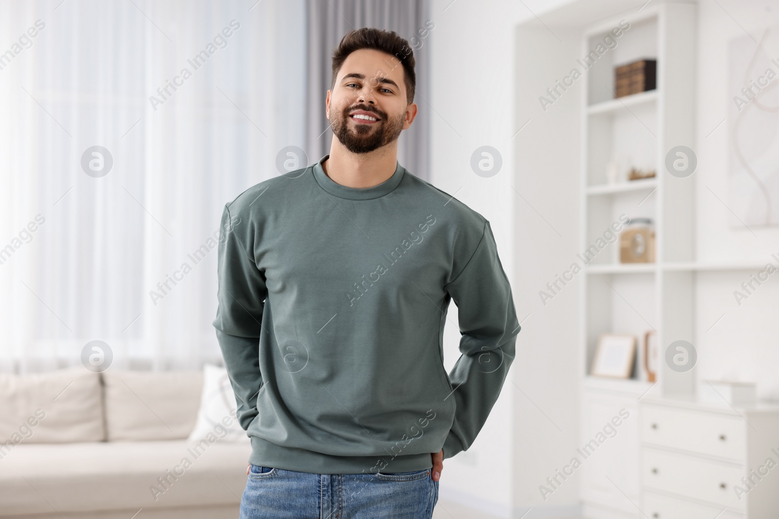 Photo of Happy man in stylish sweater at home