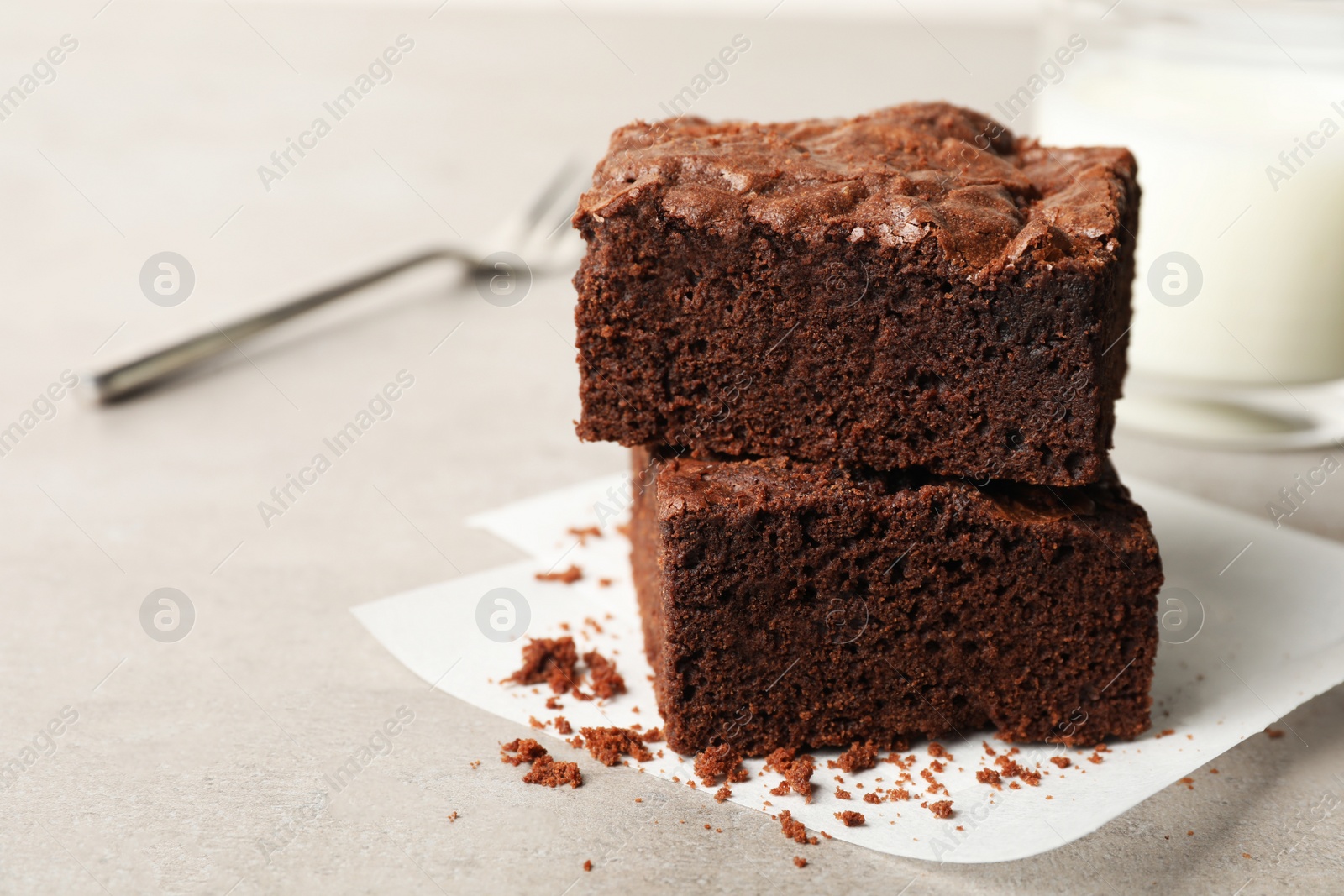 Photo of Fresh brownies on table, closeup with space for text. Delicious chocolate pie