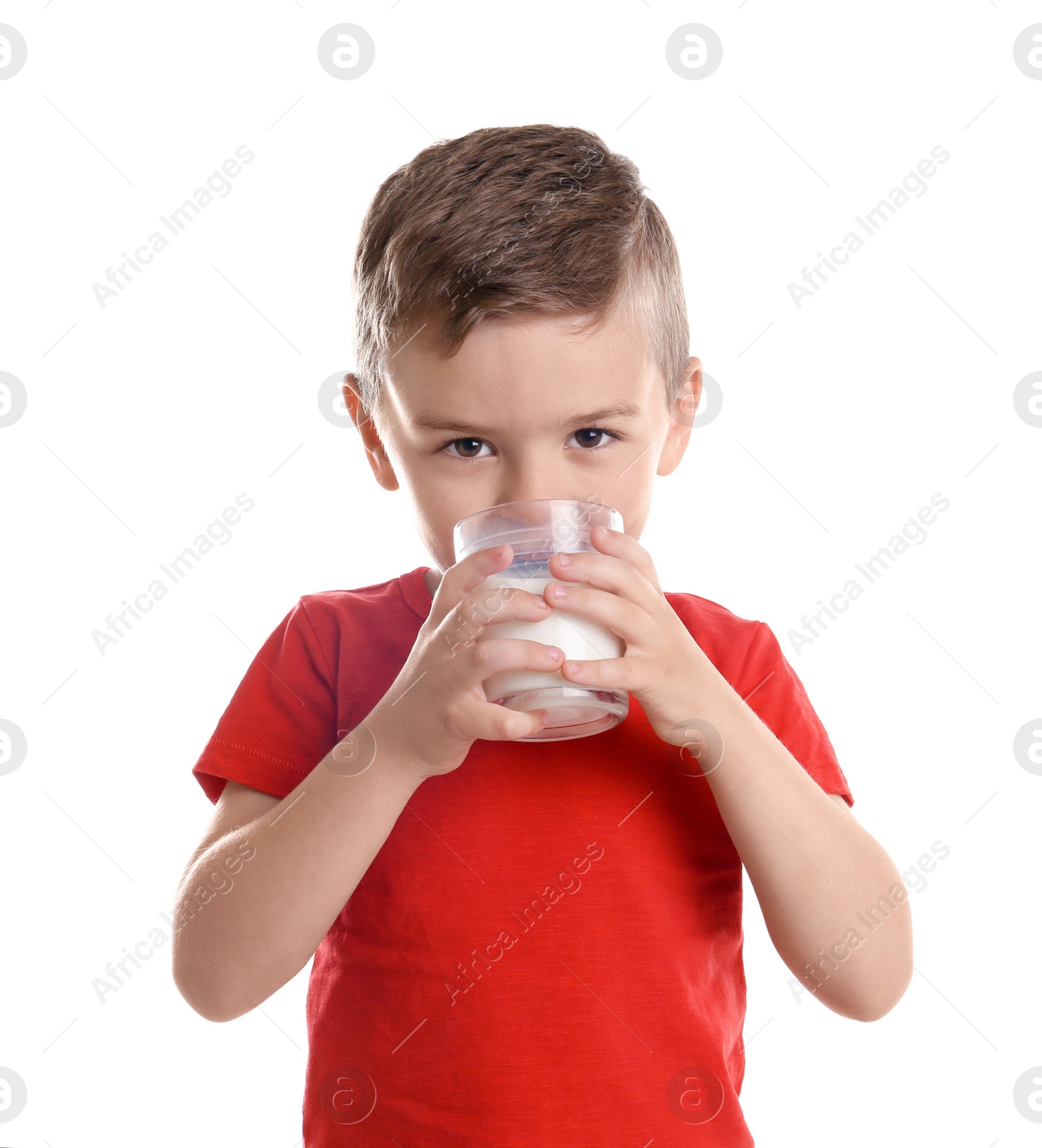 Photo of Cute little boy drinking milk on white background