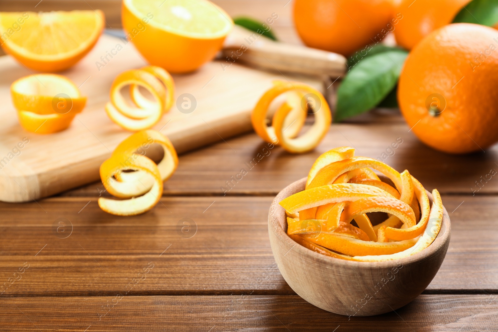 Photo of Fresh orange fruit peels on wooden table