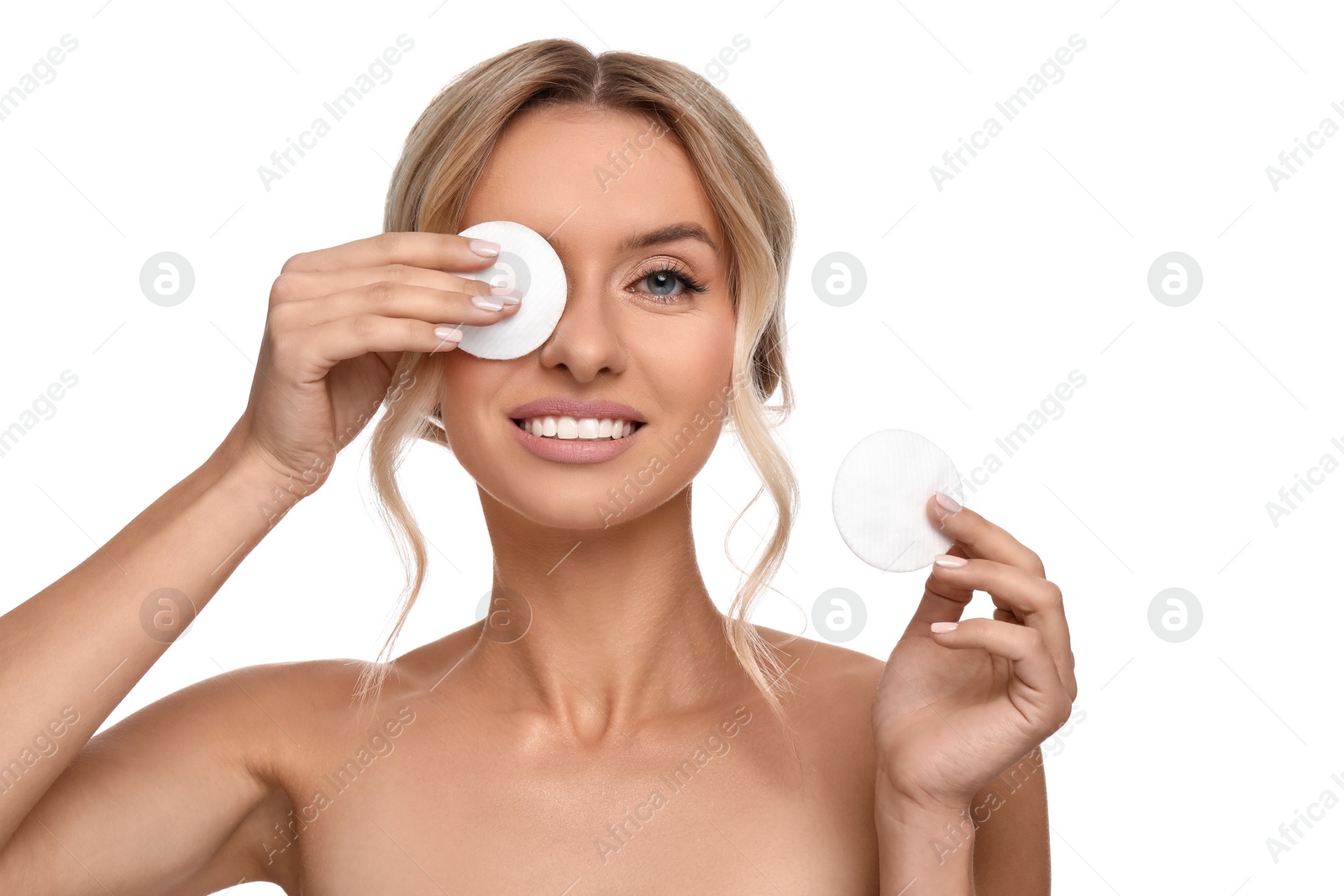 Photo of Smiling woman removing makeup with cotton pads on white background