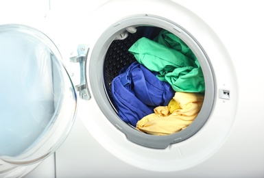 Photo of Washing machine with clothes, closeup. Laundry day