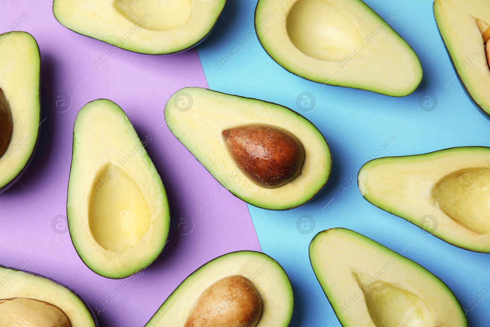 Photo of Cut fresh ripe avocados on color background, flat lay