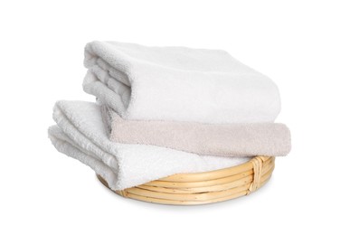 Photo of Wicker basket with folded bath towels isolated on white