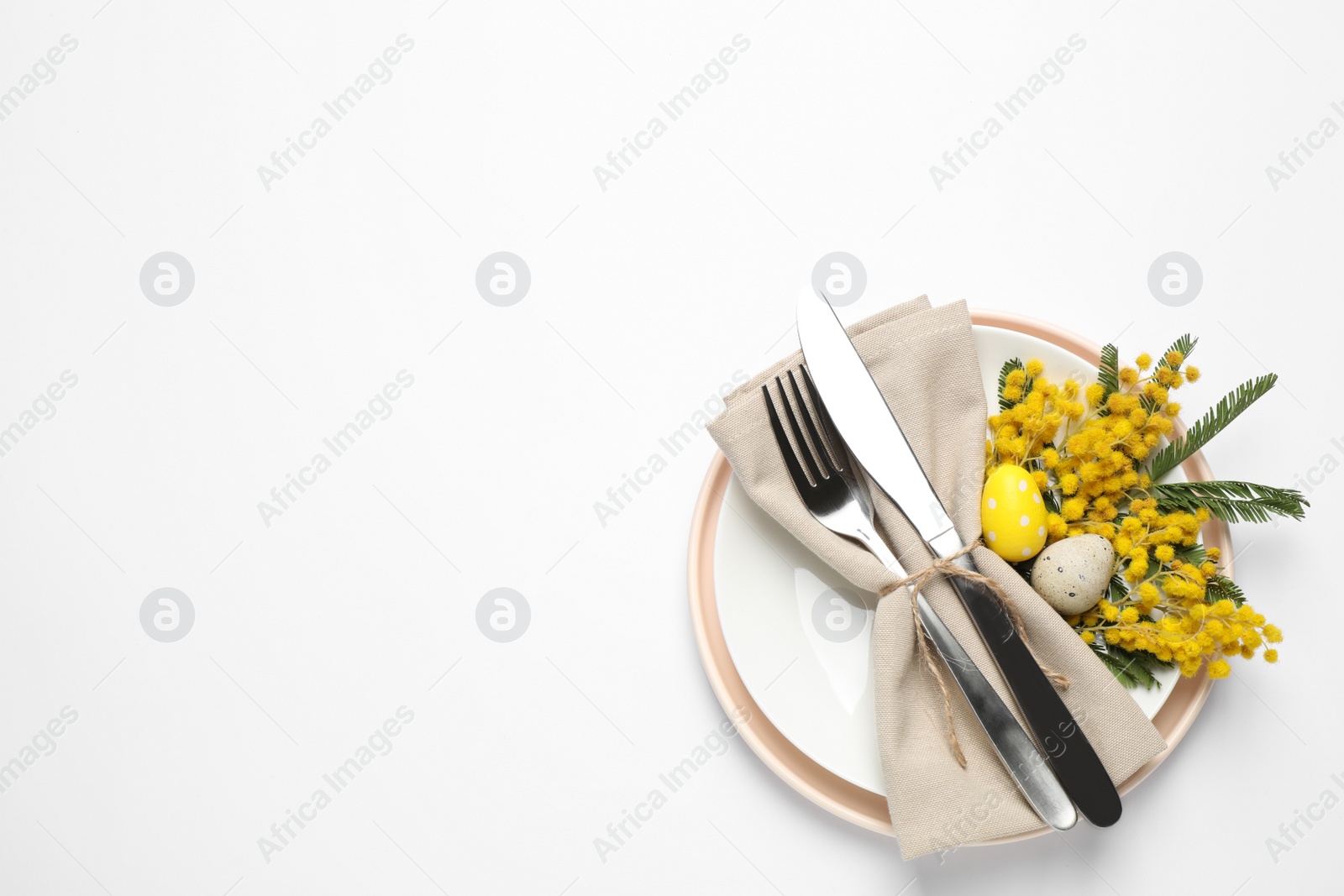 Photo of Festive Easter table setting with floral decor on white background, top view