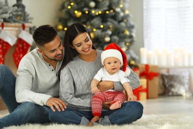 Photo of Happy family with cute baby at home. Christmas celebration