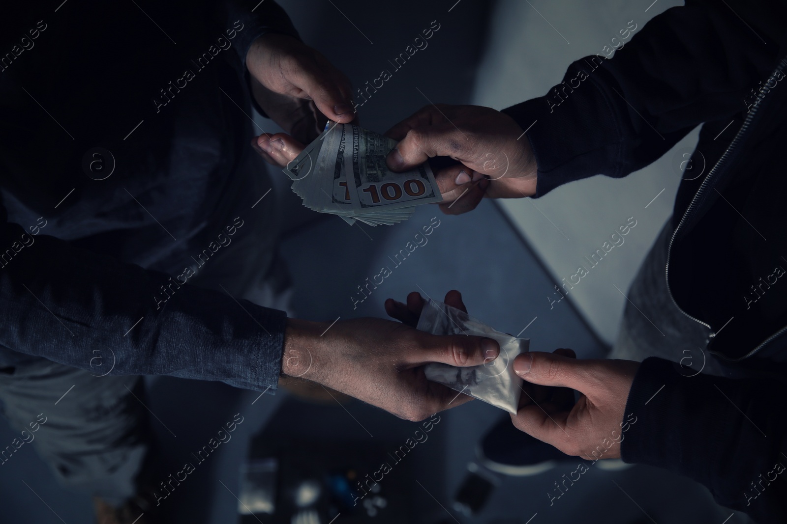 Photo of Addicted man buying drugs from dealer on blurred background, closeup