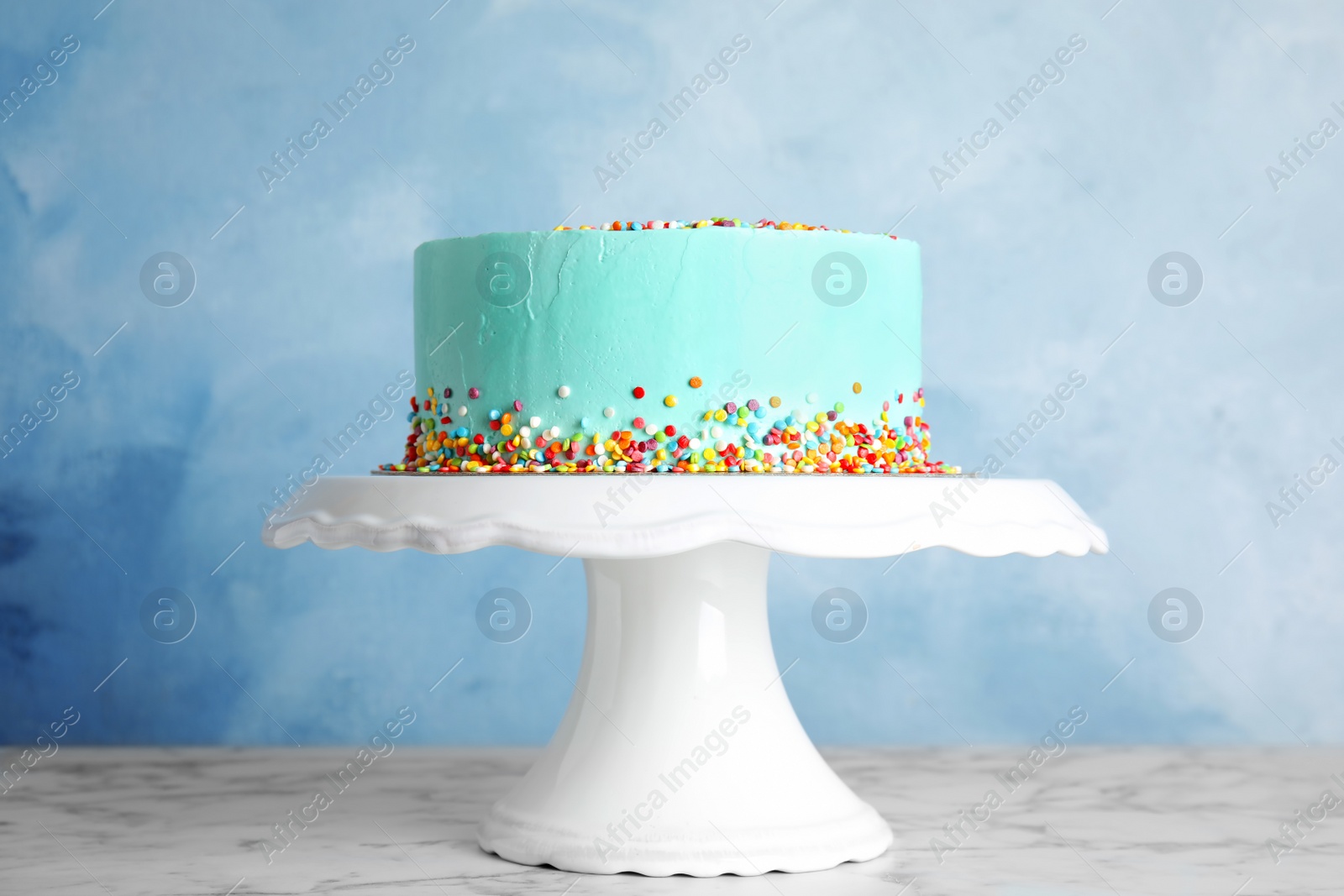 Photo of Fresh delicious birthday cake on stand against color background