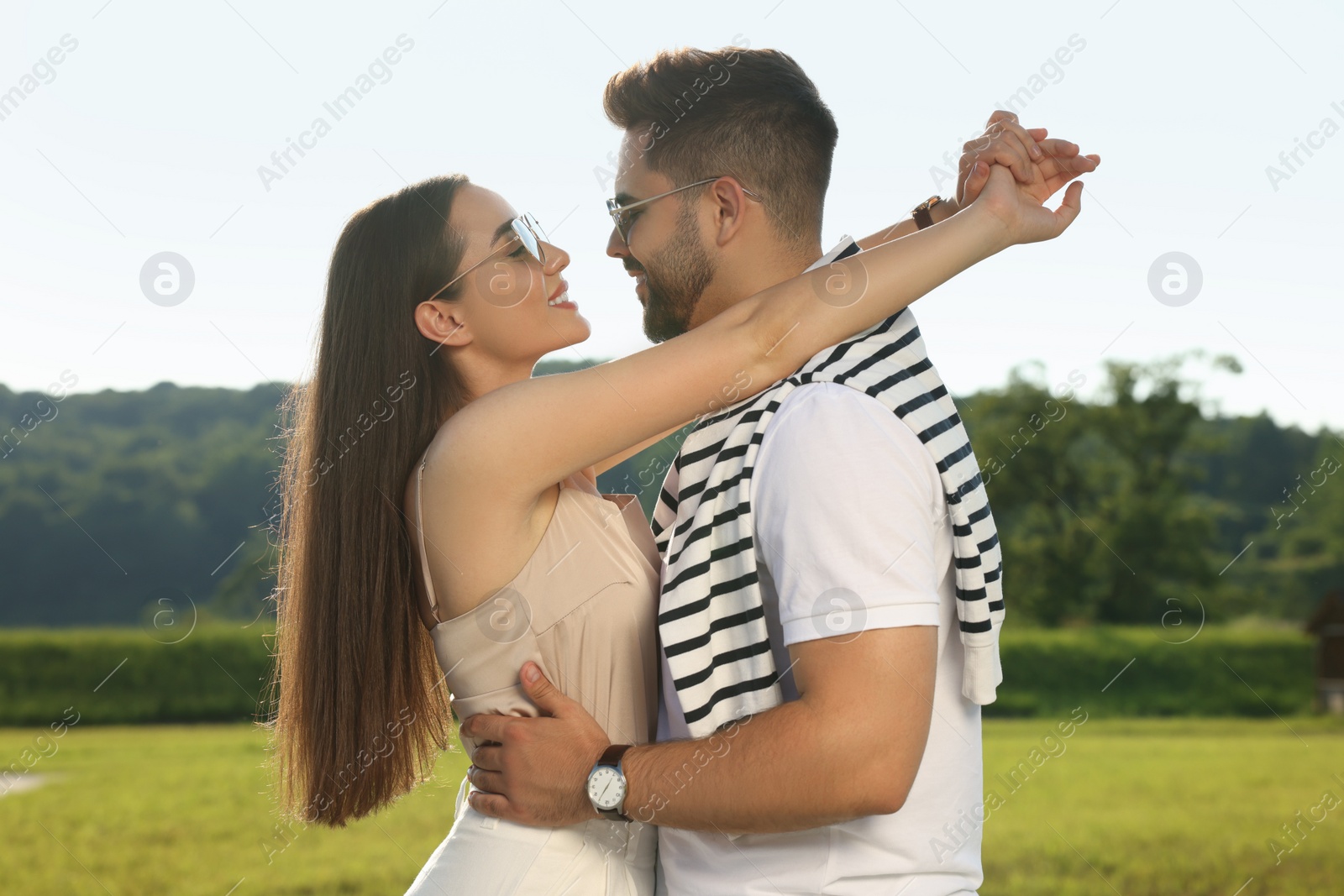 Photo of Romantic date. Beautiful couple spending time together in park