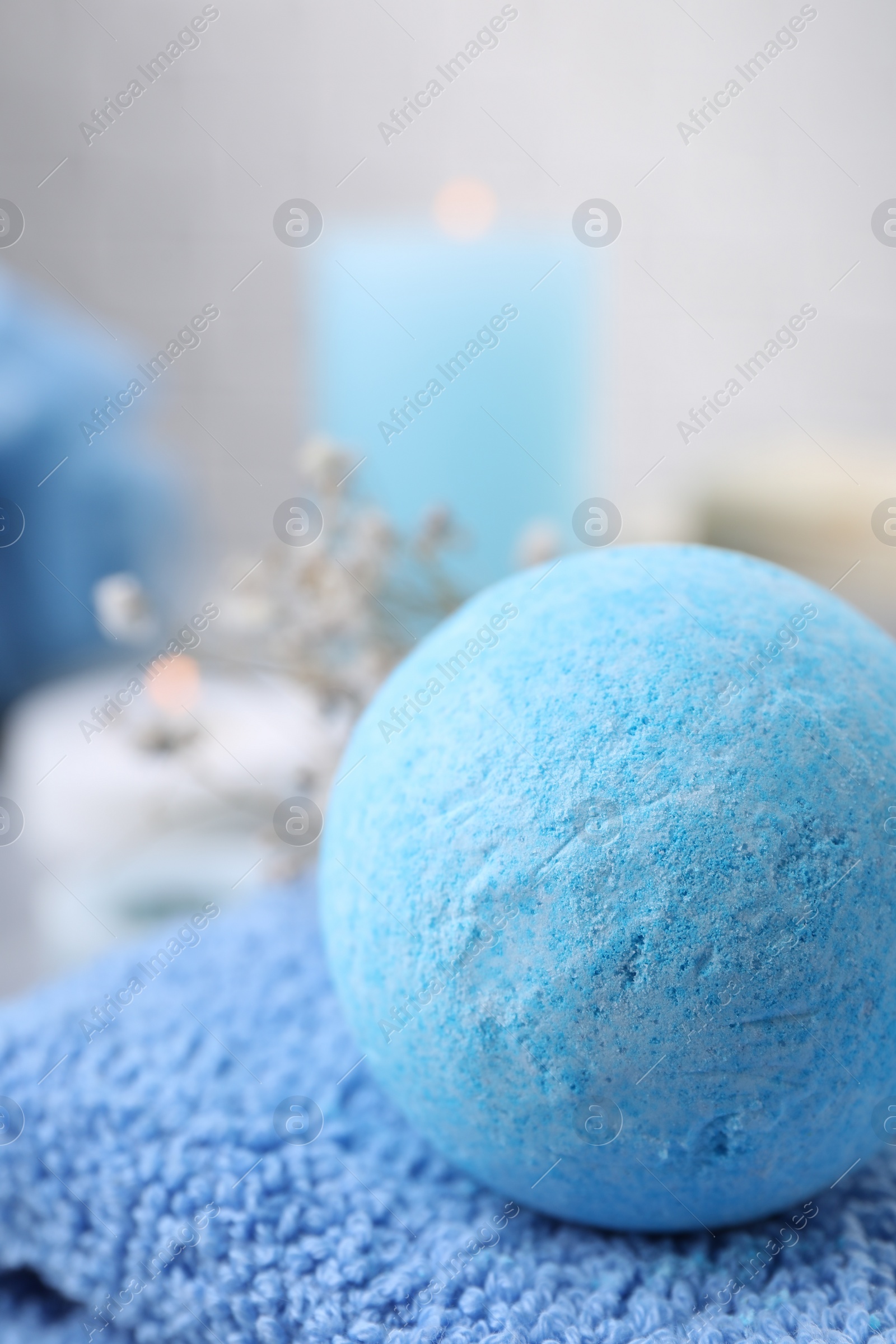 Photo of Beautiful aromatic bath bomb on towel, closeup. Space for text