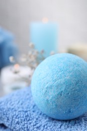 Beautiful aromatic bath bomb on towel, closeup. Space for text