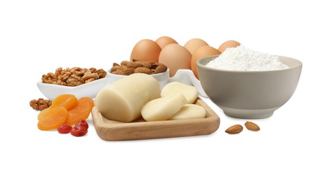 Photo of Marzipan and other ingredients for homemade Stollen on white background. Baking traditional German Christmas bread