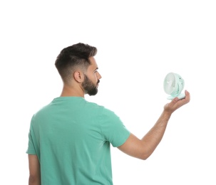 Photo of Man with portable fan on white background. Summer heat