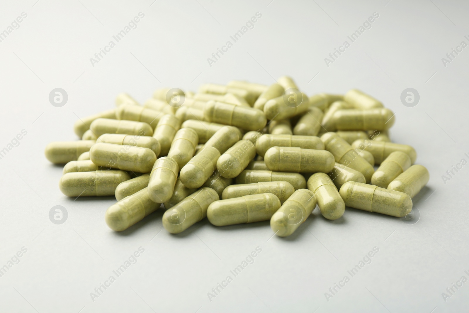 Photo of Vitamin capsules on light grey background. Health supplement