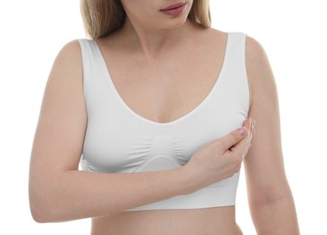 Photo of Mammology. Young woman doing breast self-examination on white background, closeup