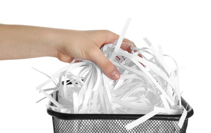 Photo of Woman taking shredded paper strips into trash bin on white background, closeup