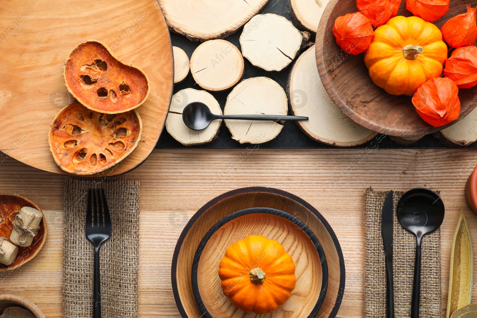 Photo of Autumn table setting with pumpkins on wooden background, flat lay