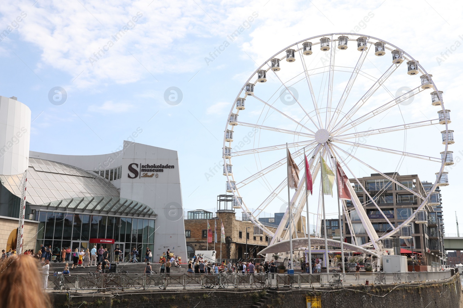 Photo of Cologne, Germany - August 28, 2022: Picturesque view of Ferris wheel in city near canal