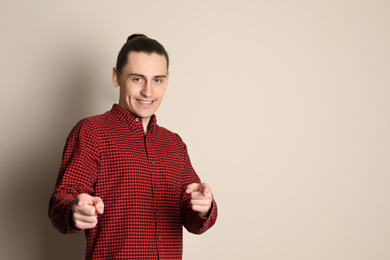 Photo of Portrait of happy young man on beige background. Space for text