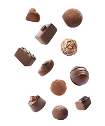 Falling different chocolate candies on white background