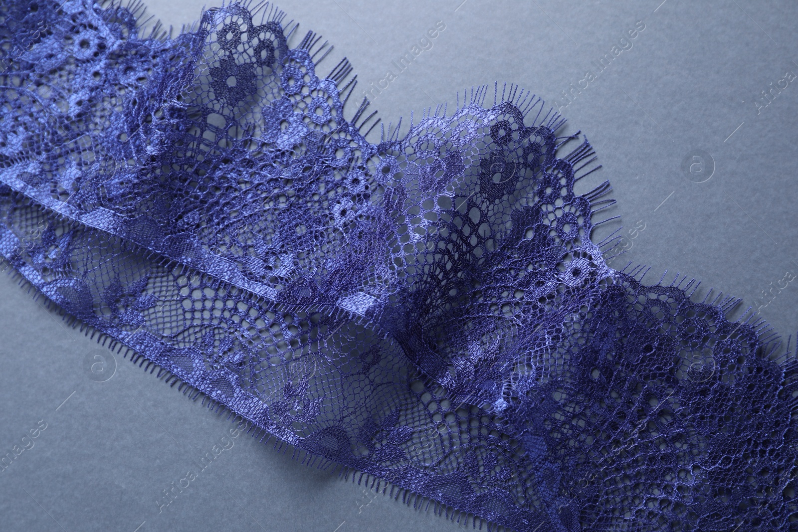 Photo of Beautiful lace on light blue background, top view