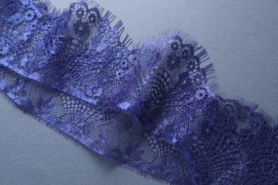 Photo of Beautiful lace on light blue background, top view