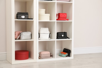 Wardrobe shelves with different stylish bags indoors. Idea for interior design