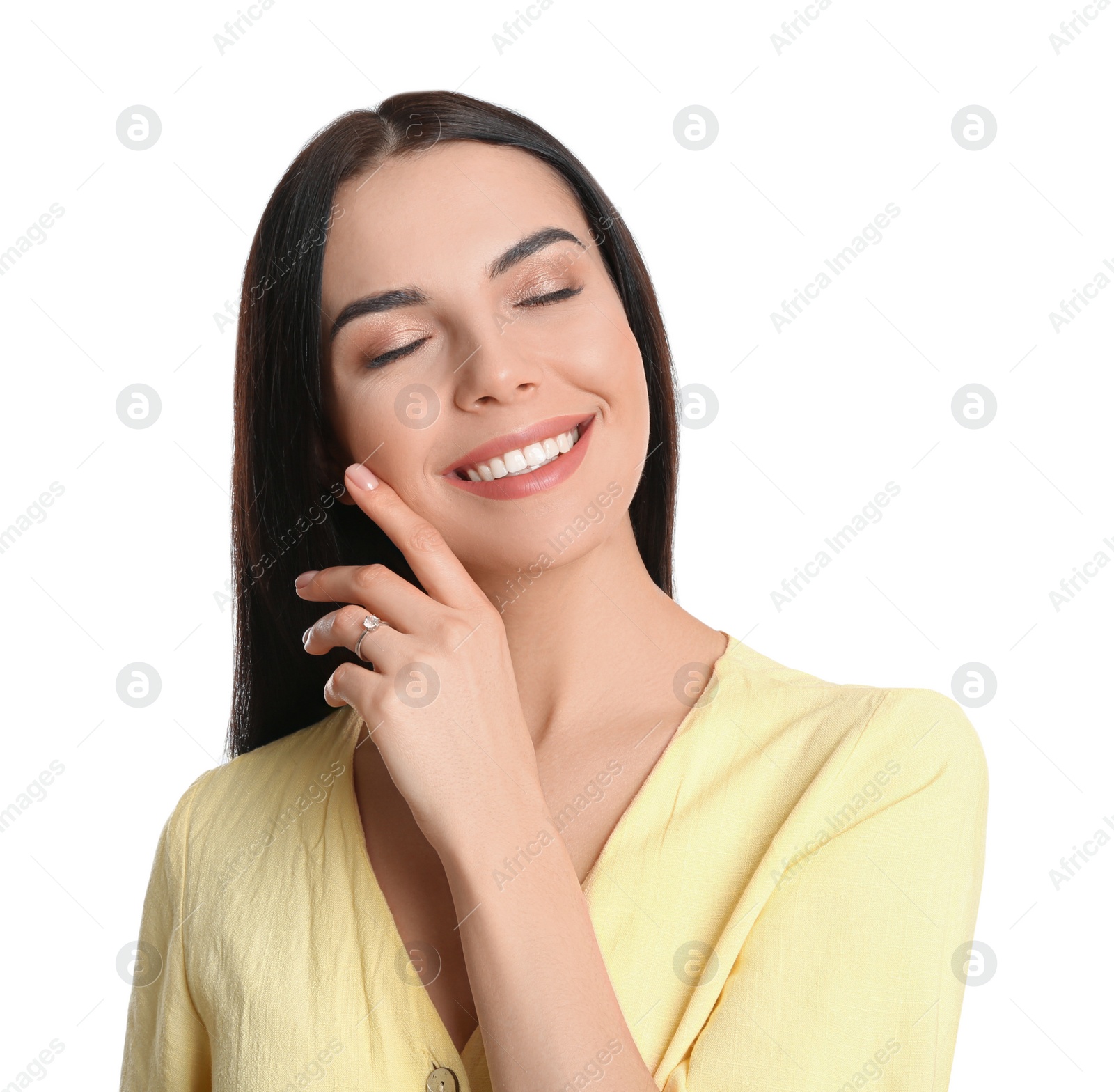 Photo of Happy young woman wearing beautiful engagement ring on white background