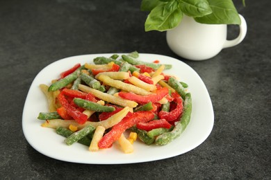 Mix of different frozen vegetables on gray table, closeup