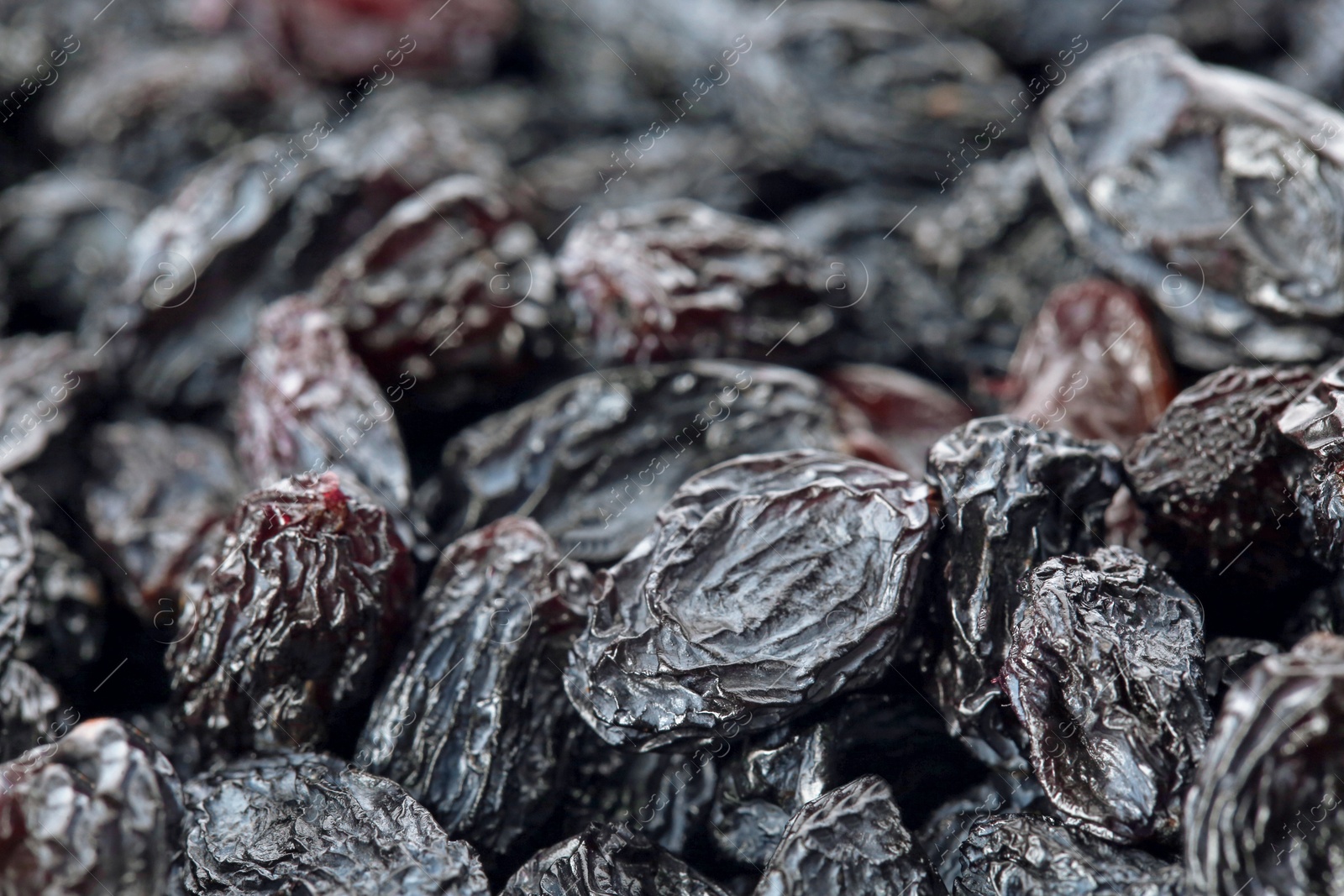 Photo of Tasty raisins as background, closeup. Healthy dried fruit