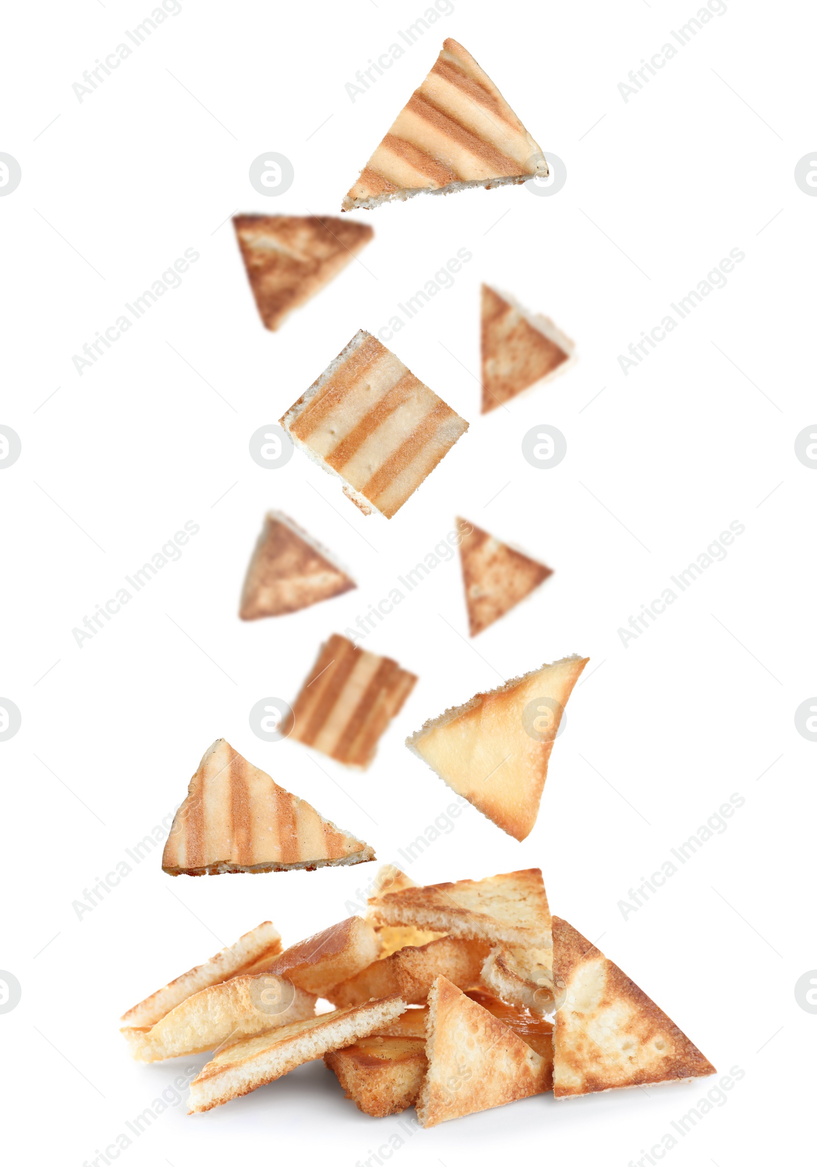 Image of Delicious crispy pita chips falling into heap on white background