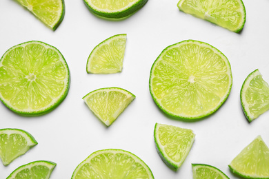Photo of Juicy fresh lime slices on white background, top view