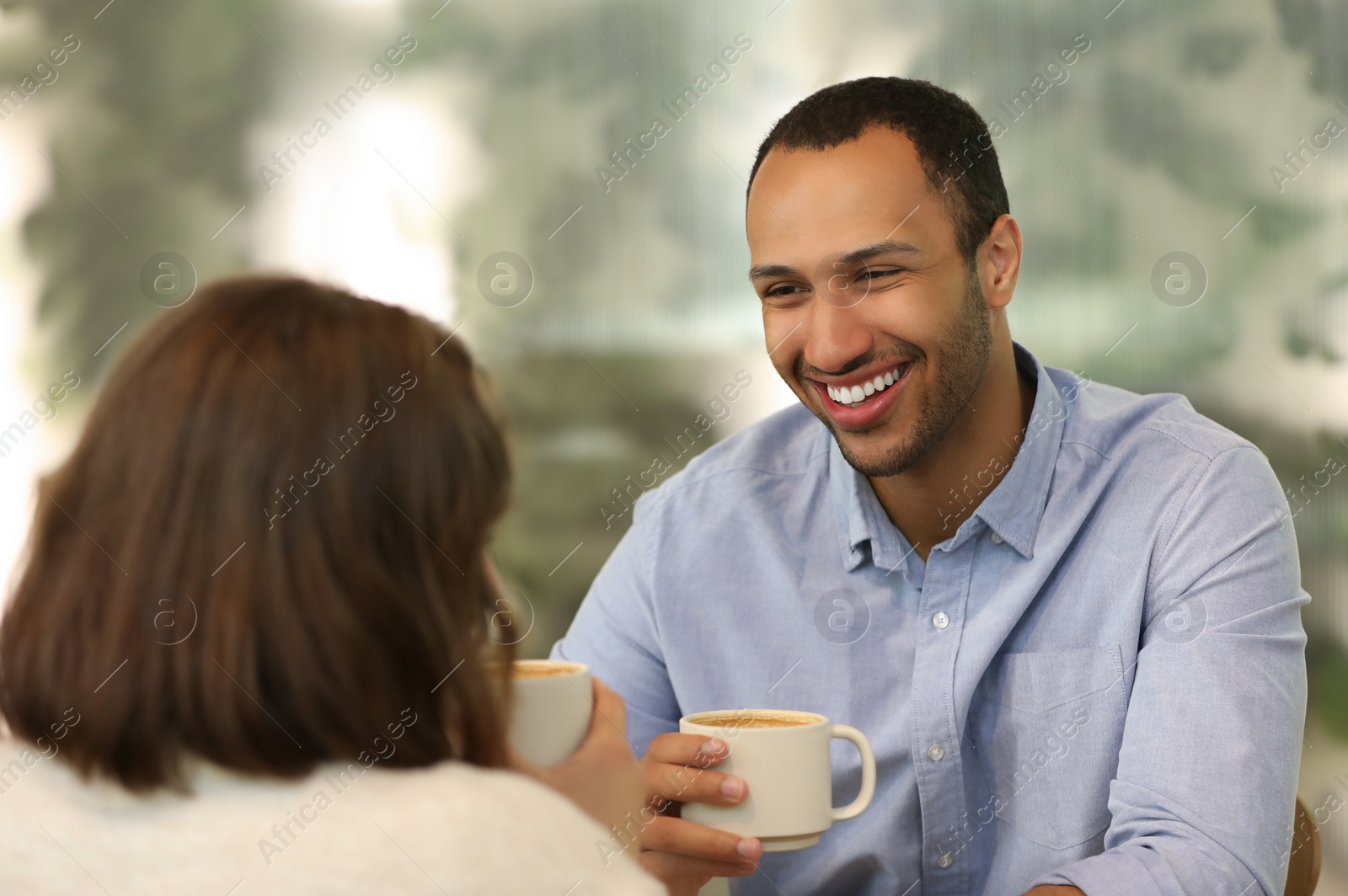 Photo of Romantic date. Happy couple spending time together in cafe