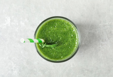 Photo of Fresh green juice on light grey table, top view