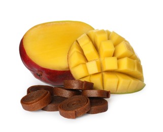 Photo of Delicious fruit leather rolls and mango on white background
