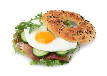 Photo of Tasty bagel with cured ham, egg, cucumber and salad mix isolated on white