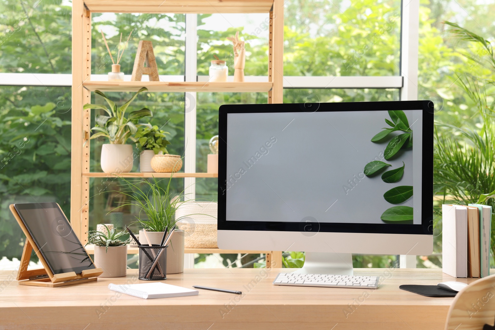 Photo of Comfortable workplace with computer in light room. Interior design