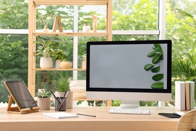 Comfortable workplace with computer in light room. Interior design